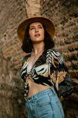 portrait of latin woman with hat looking up towards the sunset