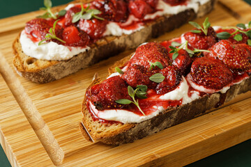 Baked strawberries with honey and thyme atop ricotta-slathered toast. - obrazy, fototapety, plakaty