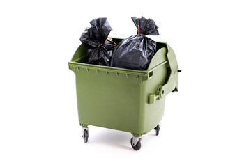 A green dust bin full of rubbish sacks