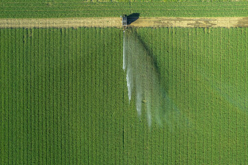 Rural field planted using hose reel system pump water from canal.Inspiring Aerial Shot.