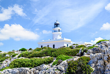 Fototapeta na wymiar Cavalleria lighthouse located in Cabo de Cavalleria of Menorca, Balearic Islands, Spain