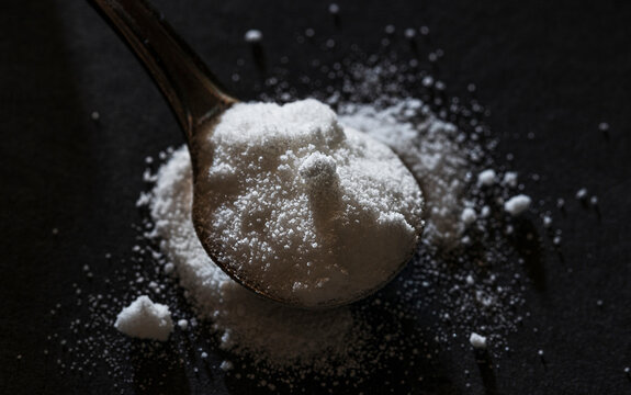 dose of white powder on a spoon. citrulline malate biohacking concept