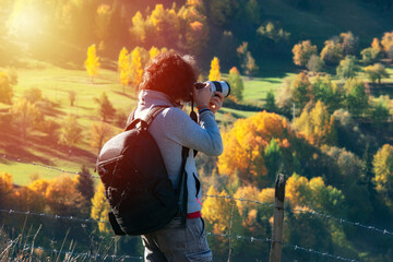 Young man traveler looking and photographing beautiful autumn in Turkey, Travel lifestyle concept. - obrazy, fototapety, plakaty