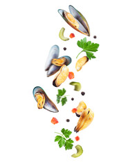 Fresh mussels with food ingredients in the air close-up isolated on a white background