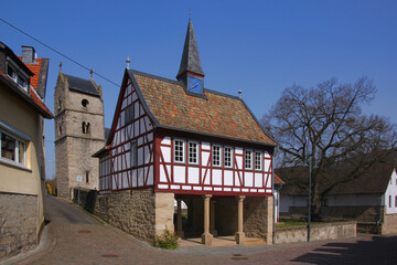 Half-timbered city hall and leaning medieval church tower in the old village of Boos in Germany