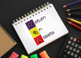 ROA - Return On Assets acronym on notepad, business concept background