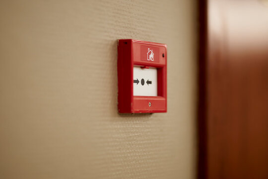 Red fire alarm button. Red fire alarm button on the wall in the room. Fire alarm button on the wall. Industrial fire alarm system equipment for emergencies. emergency fire alarm.