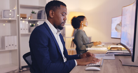 Business, night and black man typing on computer in office working late for planning, proposal and project. Corporate, focus and male worker at desk for writing email, website research and report