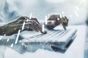 Multi exposure of abstract financial diagram with world map and with hand typing on computer keyboard on background, banking and accounting concept