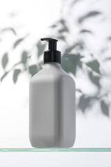 A mockup of a white dispenser with a cosmetic product for skin care of the face and body. Shower gel, facial cleanser.
