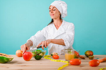 Woman chef prepares a new receipt with fruits