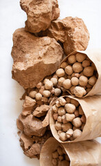 Edible brown and caramel clay stones on a white background flat lay