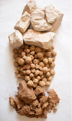 Edible caramel clay stones with white and brown clay stones on a white background flat lay