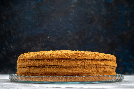 a front view round honey cake delicious and baked on the grey desk cake biscuit sugar sweet photo
