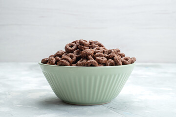 front view chocolate cereals inside green plate on the light background breakfast food meal cacao