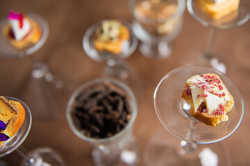 top view of various gastronomic appetizers placed on returned glasses with a beautiful bokeh, original set up
