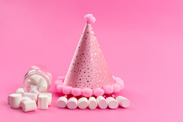 a front view white marshmallows inside can around pink birthday cap on the pink background sugar celebration birthday