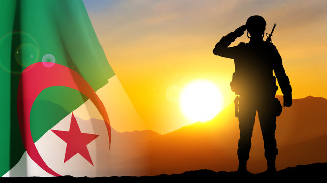 Silhouette of a soldier with Algeria flag against the sunset. EPS10 vector