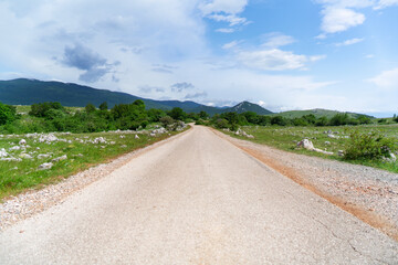 Fototapeta na wymiar Street through the hilly landscape of the Croatian Coastal Mountains.
