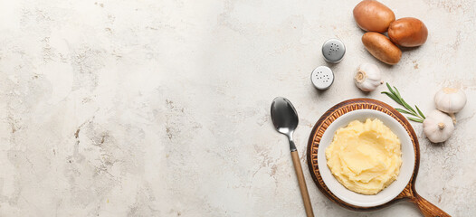 Composition with tasty mashed potato and garlic on light background with space for text