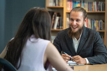 Young man in formal suit smiling with happiness at job interview. Young male candidate laughing at job interview.