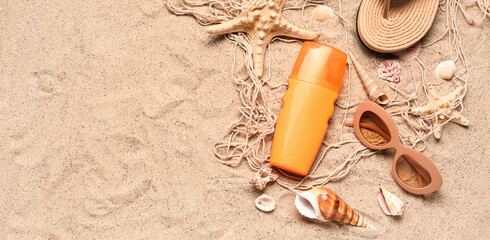 Fototapeta na wymiar Beach accessories and sea shells on sand. Banner for design