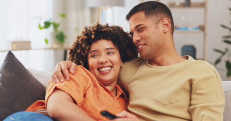 Obraz premium Film, love and entertainment with a couple watching tv on a sofa in the living room of their home together. Relax, video or television with a man and woman streaming series on a subscription service