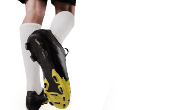 Digital png photo of legs of biracial footballer on transparent background - Powered by Adobe