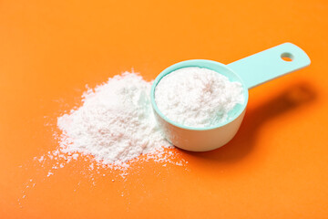 Scoop of amino acid supplement on color background