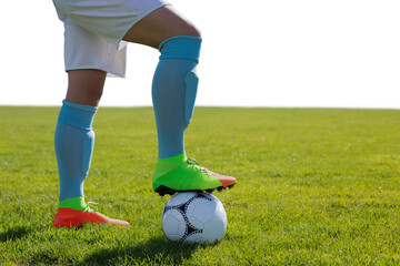 Digital png photo of legs of hispanic footballer with ball on transparent background