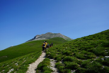 Fototapeta na wymiar Hikers walking in the mountain in a sunny day