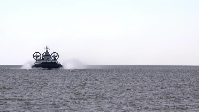 Russian hovercraft warship sails on sea ready for attack by enemy, armed military hovercraft ship