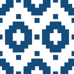 Obraz premium Seamless ikat pattern with blue elements on white background.
