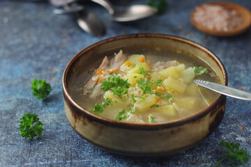 A bowl with chicken soup with pasta