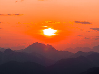 Fototapeta na wymiar The Sun Sets on the Horizon of the Alps in Tarvisio Italy