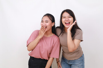 Two asian women best friends laughing and having a good time together in a studio