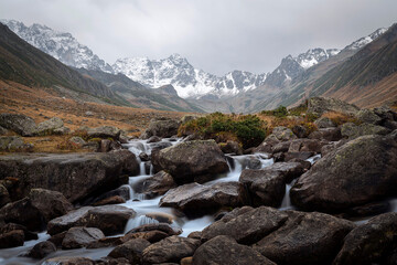 snowy Kaçkar mountains and stream flowing through rocks. Rize