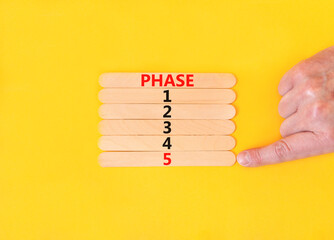 Time to phase 5 symbol. Concept word Phase 1 2 3 4 5 on wooden sticks. Businessman hand. Beautiful...