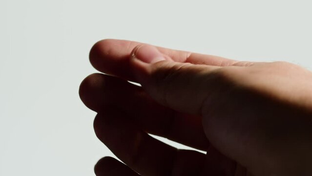 Snapping Human hand close-up, musical rhythm sound, skin texture, Clicking arm macro shooting on white background.