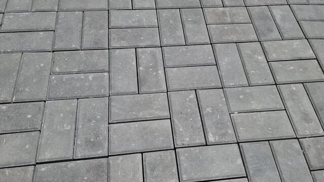Rectangular gray paving slabs. Angled view. Close-up.