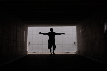 Silhouette of a man. Go forward. Towards the future. Hands spread wide. Courage for change. Free...