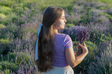 pretty young girl in a lavender provence at sunset. provence girl at lavender flowers. Adorable girl in lavender provence during summer holidays. Portrait of a girl in lavender provence