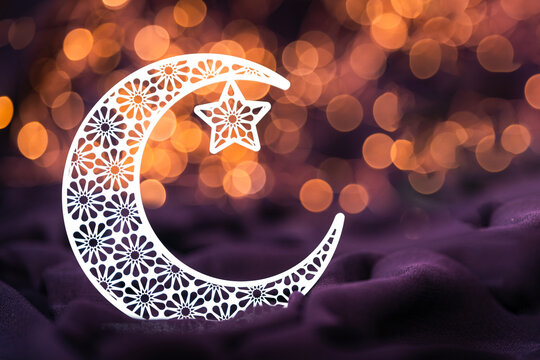 Eid Al Adha and Ramadan Mubarak concept greeting image, Beautiful crescent moon shape isolated on bokeh light 