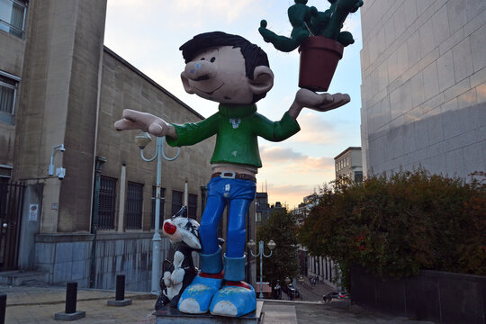 Brussels, Belgium - October 13th 2017 : Focus on a statue of the comic character Gaston Lagaffe, located at the beggining of the street where the Comic museum is.
