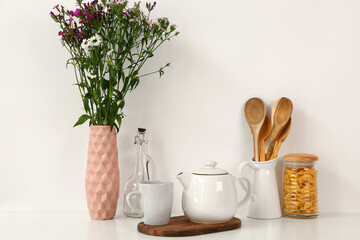 Composition with beautiful tea set and different items on white table