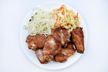 Beautiful fried pieces of pork meat. Pork kebab with vegetables. Meat on a plate.