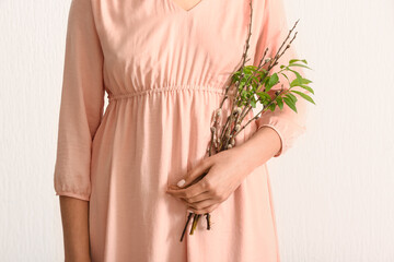 Woman with willow branches on white background, closeup