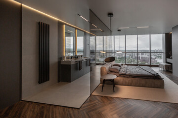 cool expensive interior design of room in prestigious luxury hotel with dark tones with modern LED lighting and stylish furniture. the area with a sink is separated by dark glass from the bedroom - obrazy, fototapety, plakaty