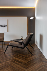 cool expensive interior design of room in prestigious luxury hotel with dark tones with modern LED lighting and stylish furniture. the area with a sink is separated by dark glass from the bedroom