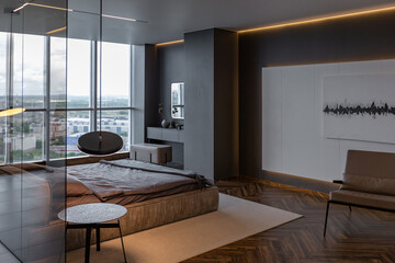 cool expensive interior design of room in prestigious luxury hotel with dark tones with modern LED lighting and stylish furniture. the area with a sink is separated by dark glass from the bedroom
